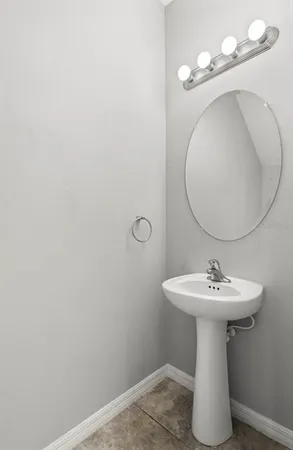 a bathroom with a sink a mirror and vanity