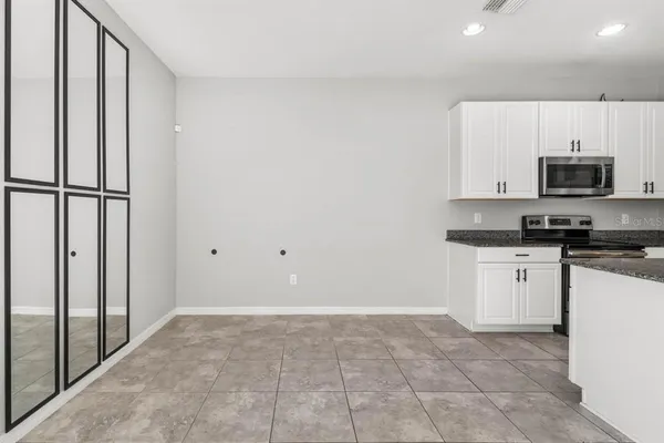 a kitchen with a refrigerator and a stove top oven