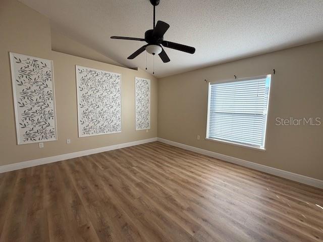 2551 Hunley Loop Kissimmee, FL 34743 - Photo 12 of 24 a view of an empty room with a window and wooden floor