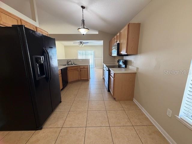 2551 Hunley Loop Kissimmee, FL 34743 - Photo 17 of 24 a kitchen with stainless steel appliances granite countertop a refrigerator a sink and a stove