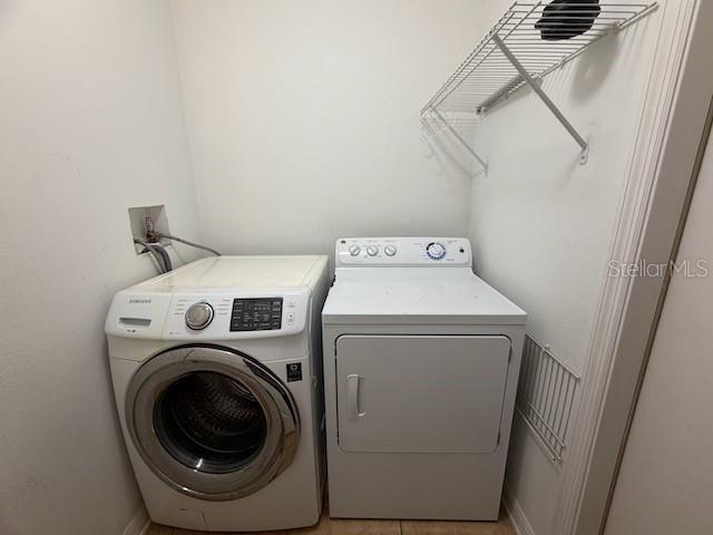 2551 Hunley Loop Kissimmee, FL 34743 - Photo 21 of 24 a utility room with dryer and washer