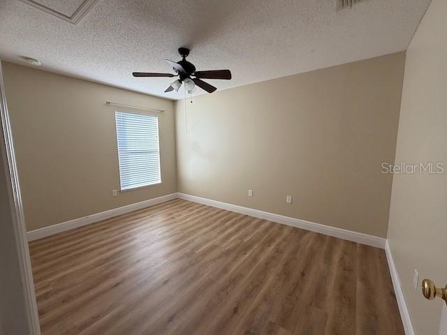 2551 Hunley Loop Kissimmee, FL 34743 - Photo 10 of 24 wooden floor in an empty room with a window