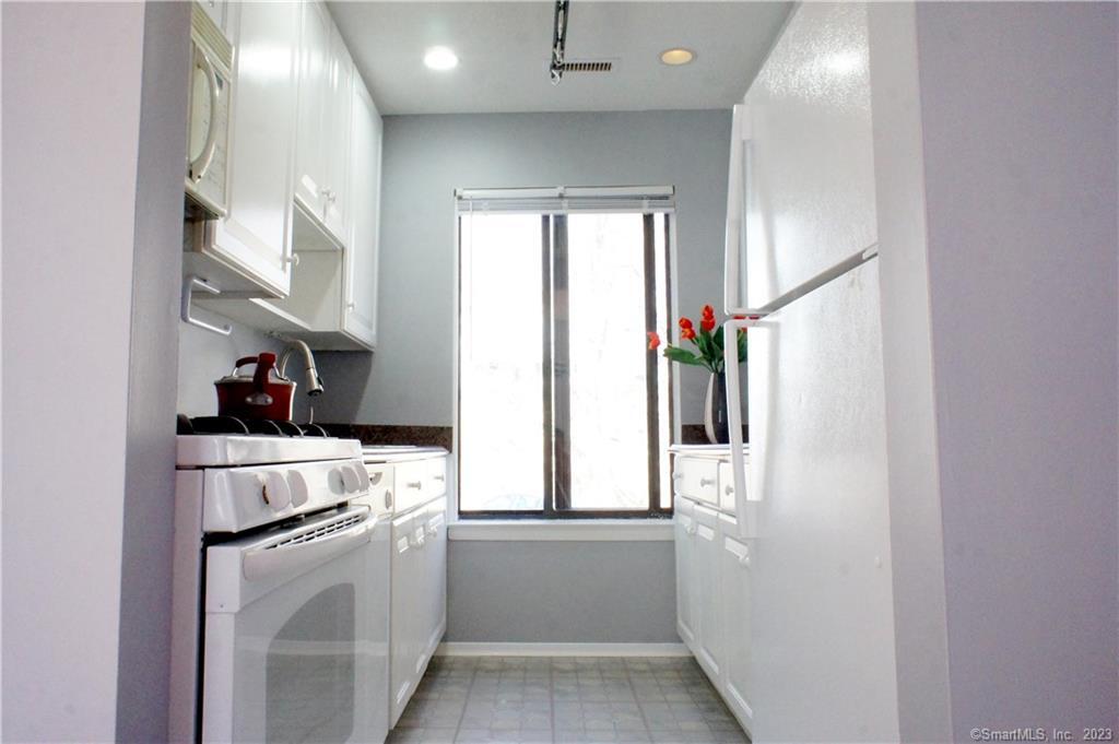 2 Juneberry Lane, Unit 2 Ridgefield, CT 06877 - Photo 10 of 29 a kitchen with stainless steel appliances a refrigerator sink and cabinets