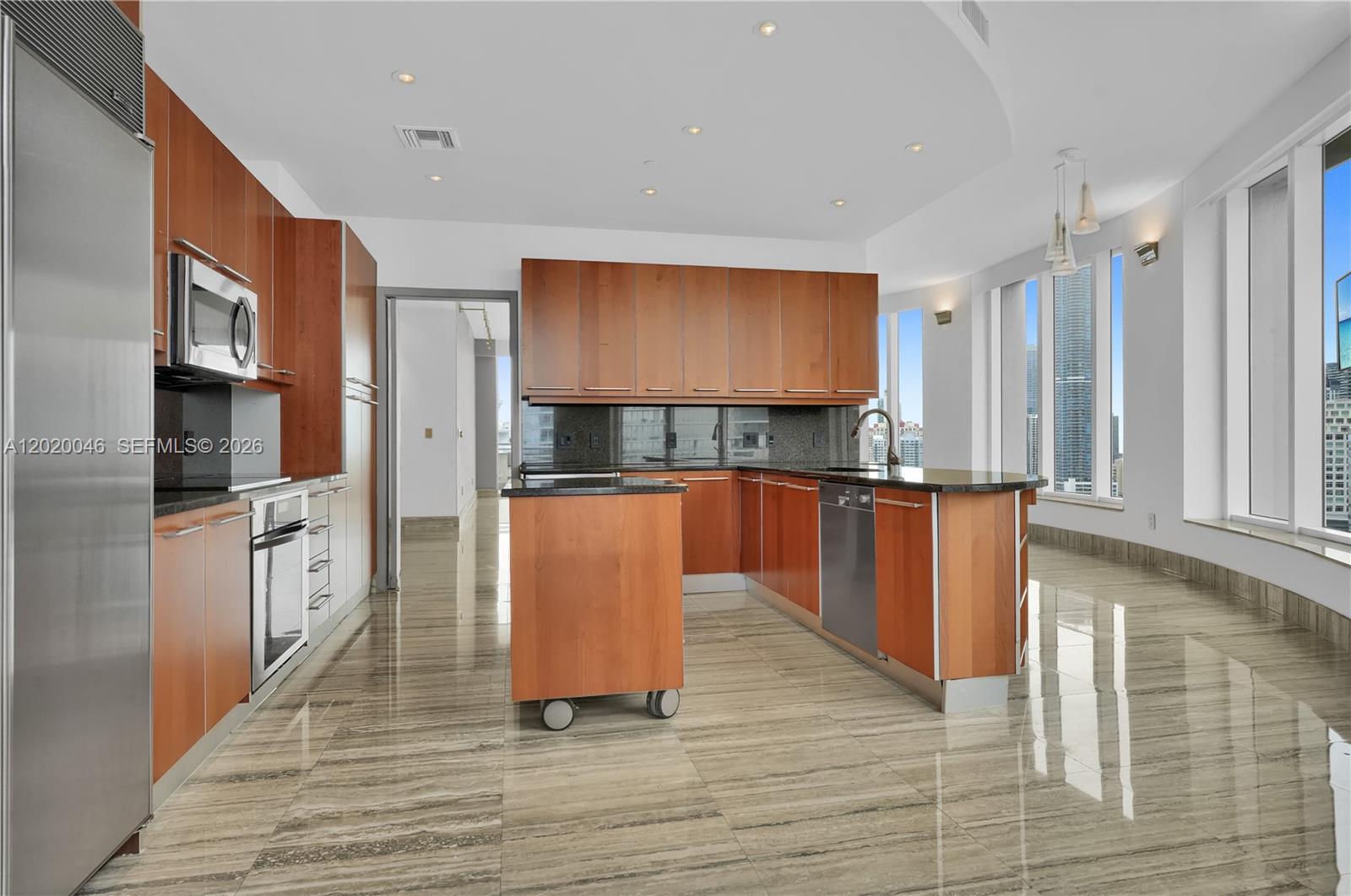 901 Brickell Key Boulevard, Unit 3204 Miami, FL 33131 - Photo 17 of 55 a kitchen with stainless steel appliances granite countertop a sink a stove top oven a counter space and cabinets