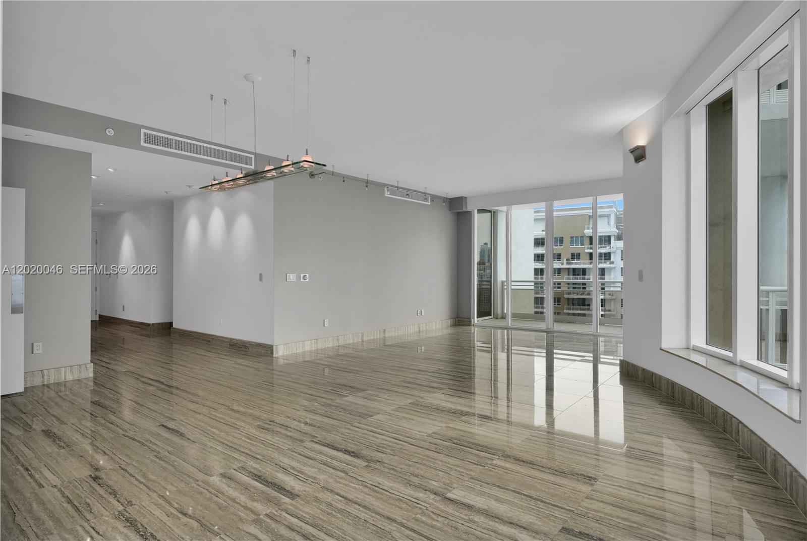 901 Brickell Key Boulevard, Unit 3204 Miami, FL 33131 - Photo 18 of 55 wooden floor in an empty room with a glass door