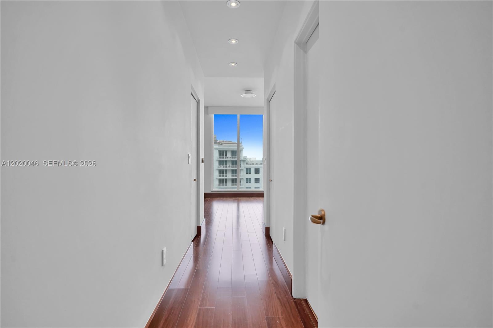 901 Brickell Key Boulevard, Unit 3204 Miami, FL 33131 - Photo 20 of 55 a view of a hallway with wooden floor