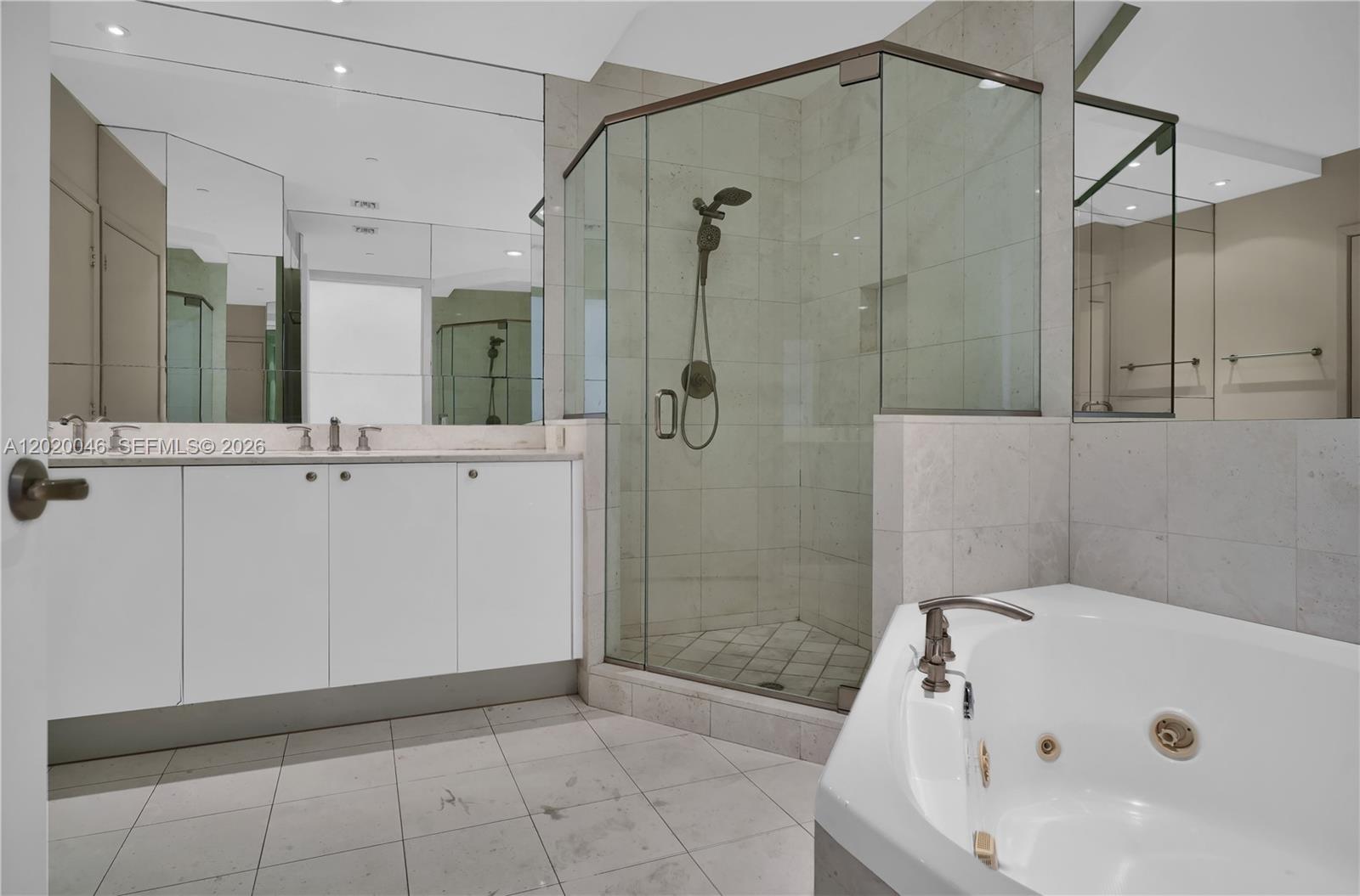 901 Brickell Key Boulevard, Unit 3204 Miami, FL 33131 - Photo 23 of 55 a bathroom with a bathtub and a shower