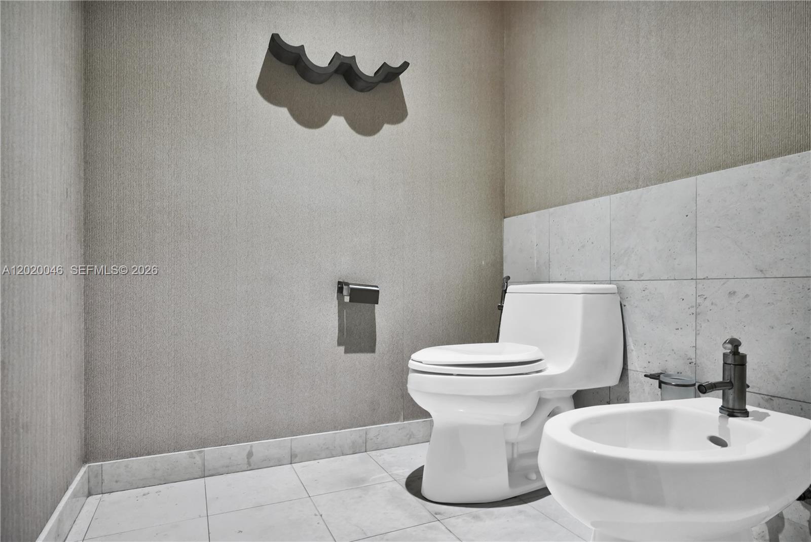 901 Brickell Key Boulevard, Unit 3204 Miami, FL 33131 - Photo 26 of 55 a white toilet sitting next to a bathroom sink