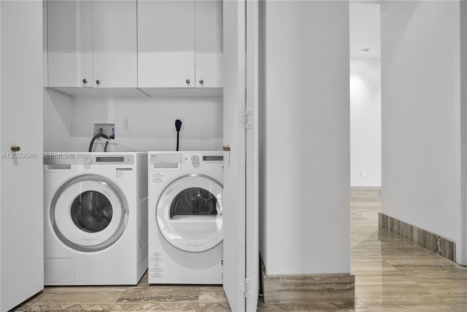 901 Brickell Key Boulevard, Unit 3204 Miami, FL 33131 - Photo 28 of 55 a utility room with dryer and washer