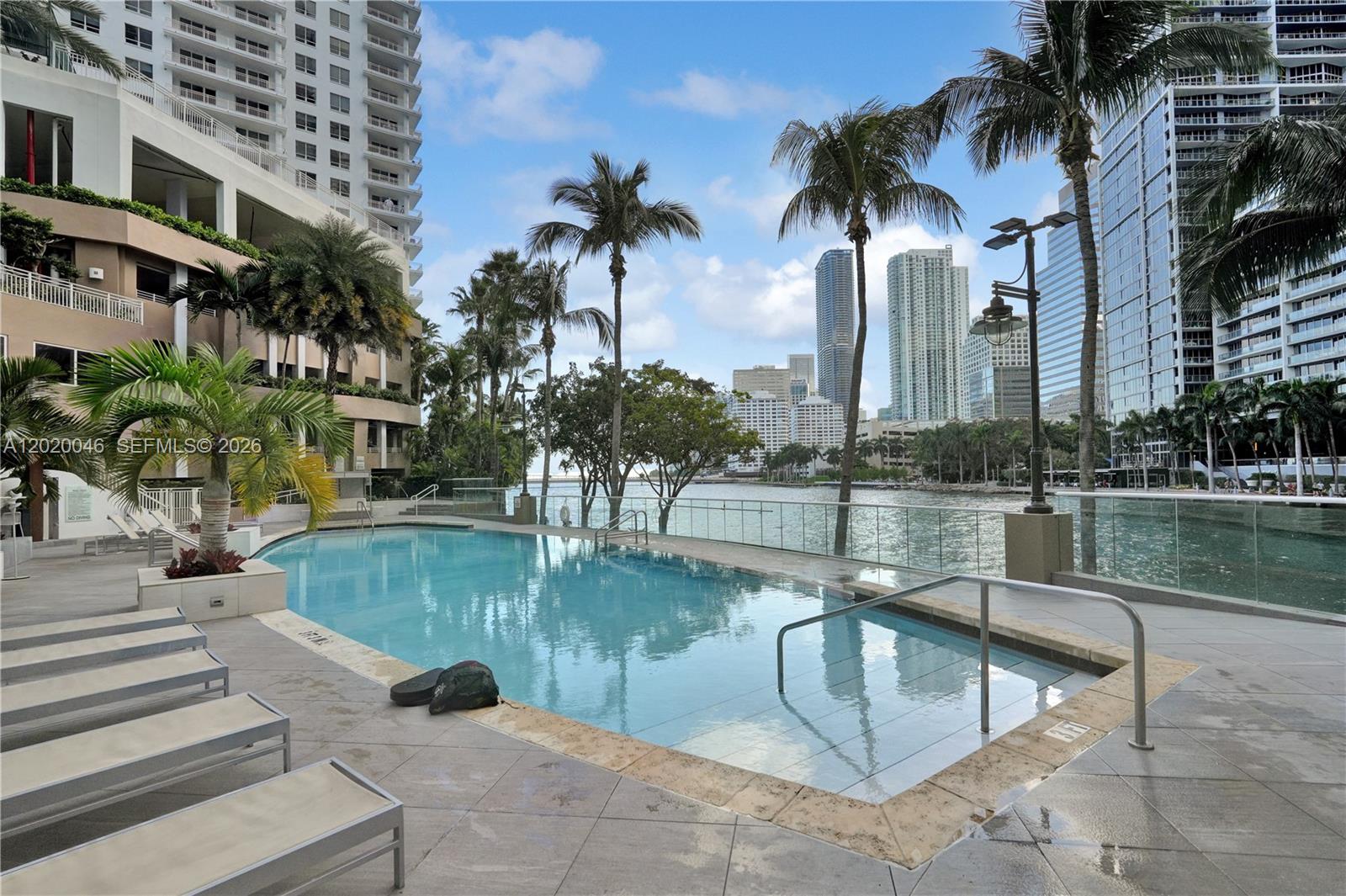 901 Brickell Key Boulevard, Unit 3204 Miami, FL 33131 - Photo 44 of 55 a view of a swimming pool with a fountain and a lake view