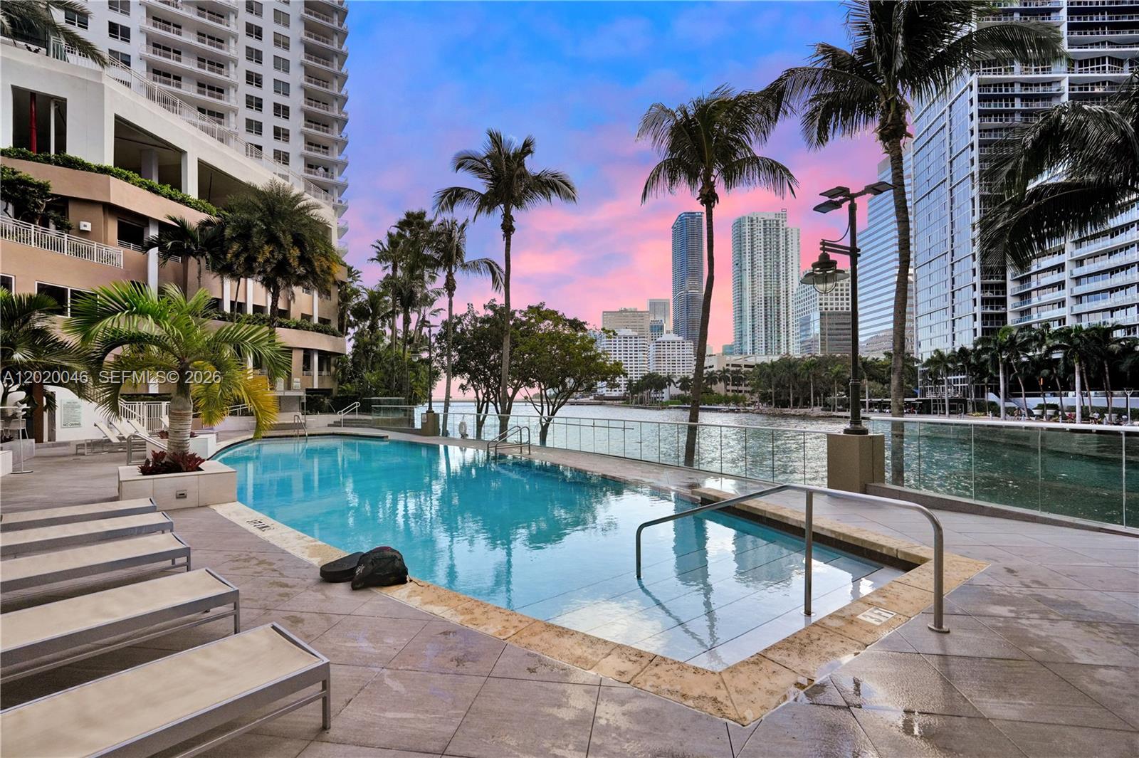 901 Brickell Key Boulevard, Unit 3204 Miami, FL 33131 - Photo 45 of 55 a view of a swimming pool with a patio and a lake view
