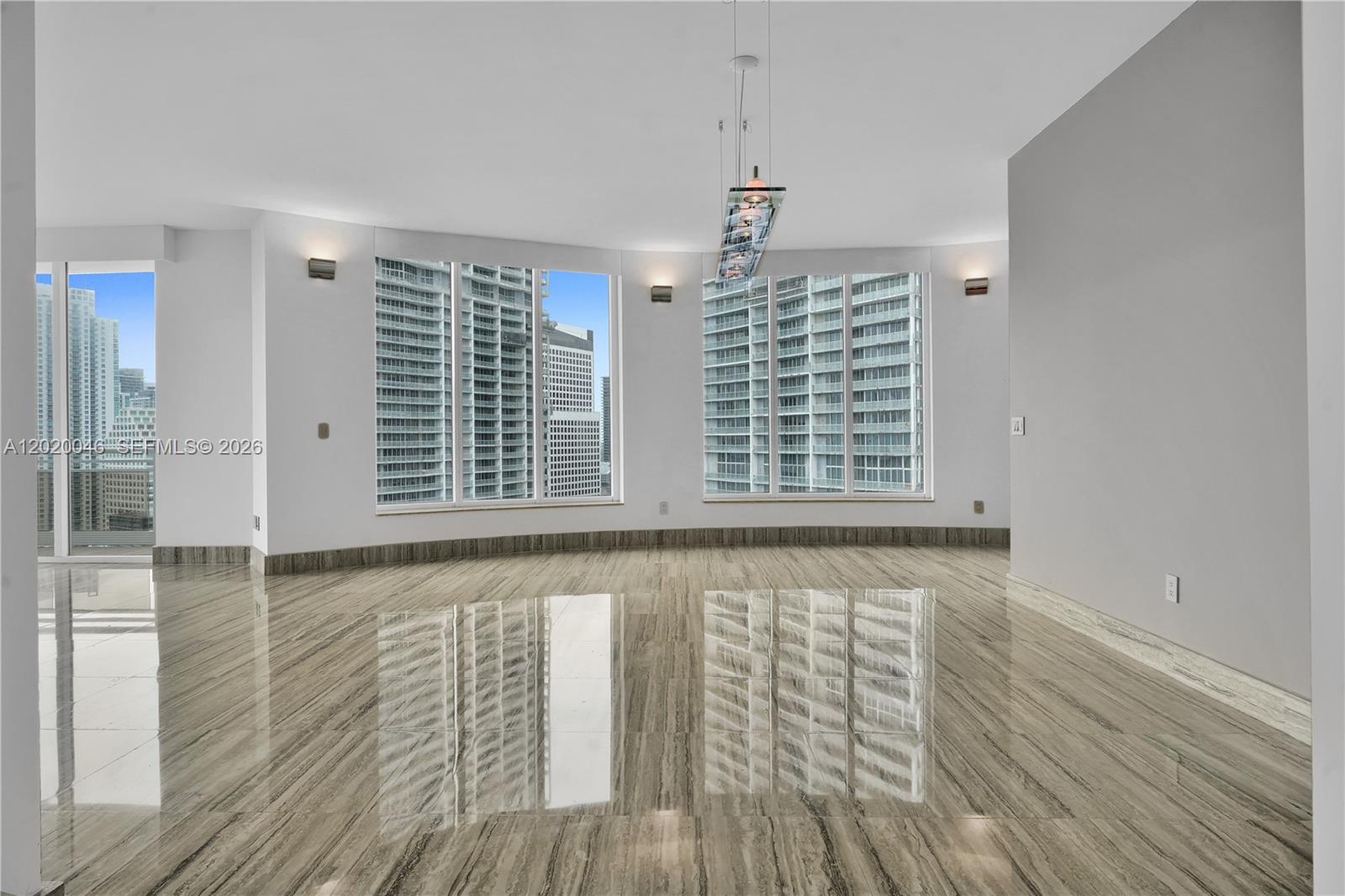 901 Brickell Key Boulevard, Unit 3204 Miami, FL 33131 - Photo 7 of 55 a view of an empty room with wooden floor and a window