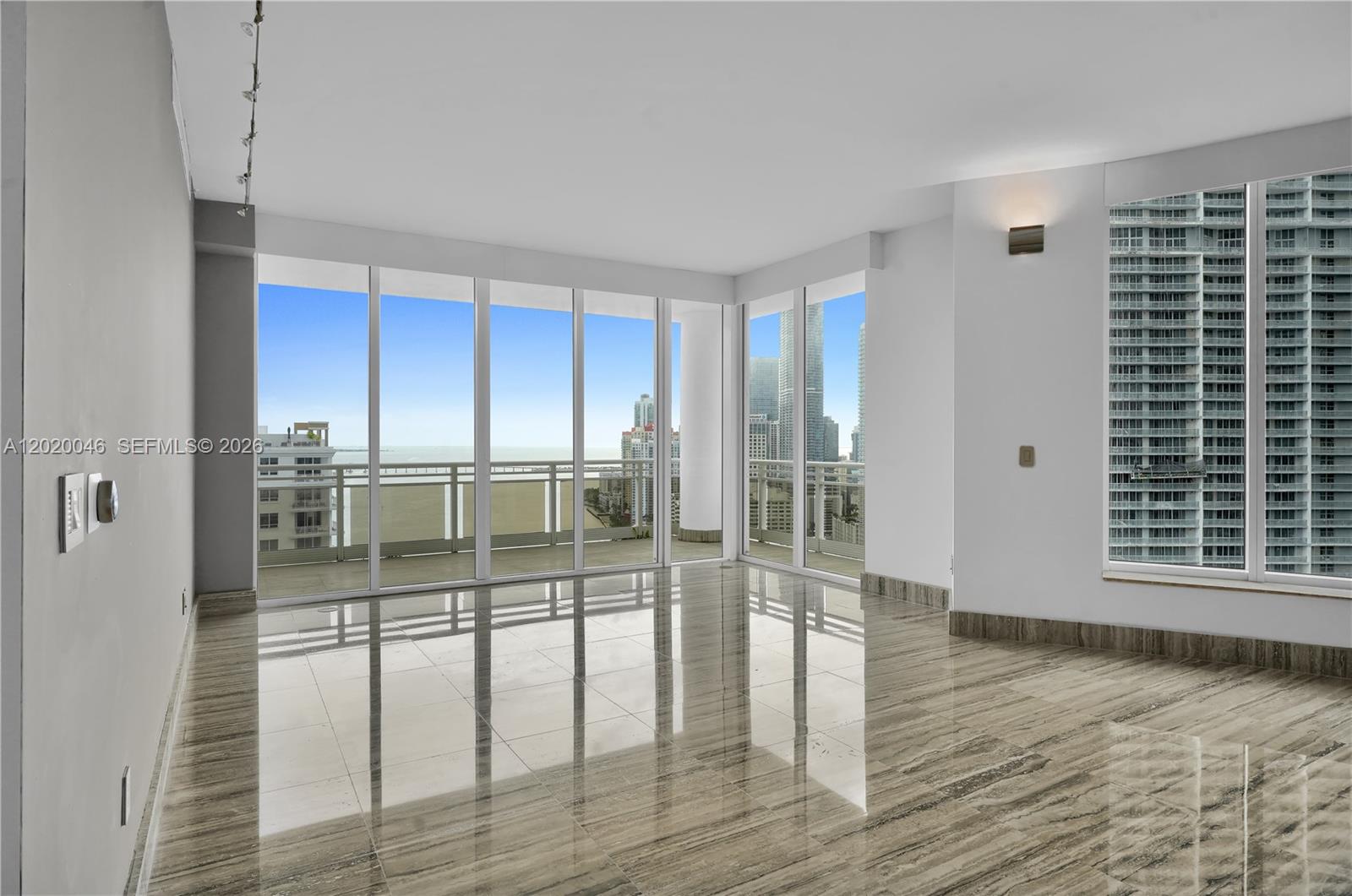 901 Brickell Key Boulevard, Unit 3204 Miami, FL 33131 - Photo 8 of 55 a view of empty room with wooden floor and fan