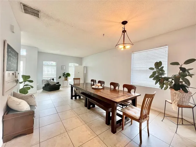 a dining room with furniture and a chandelier