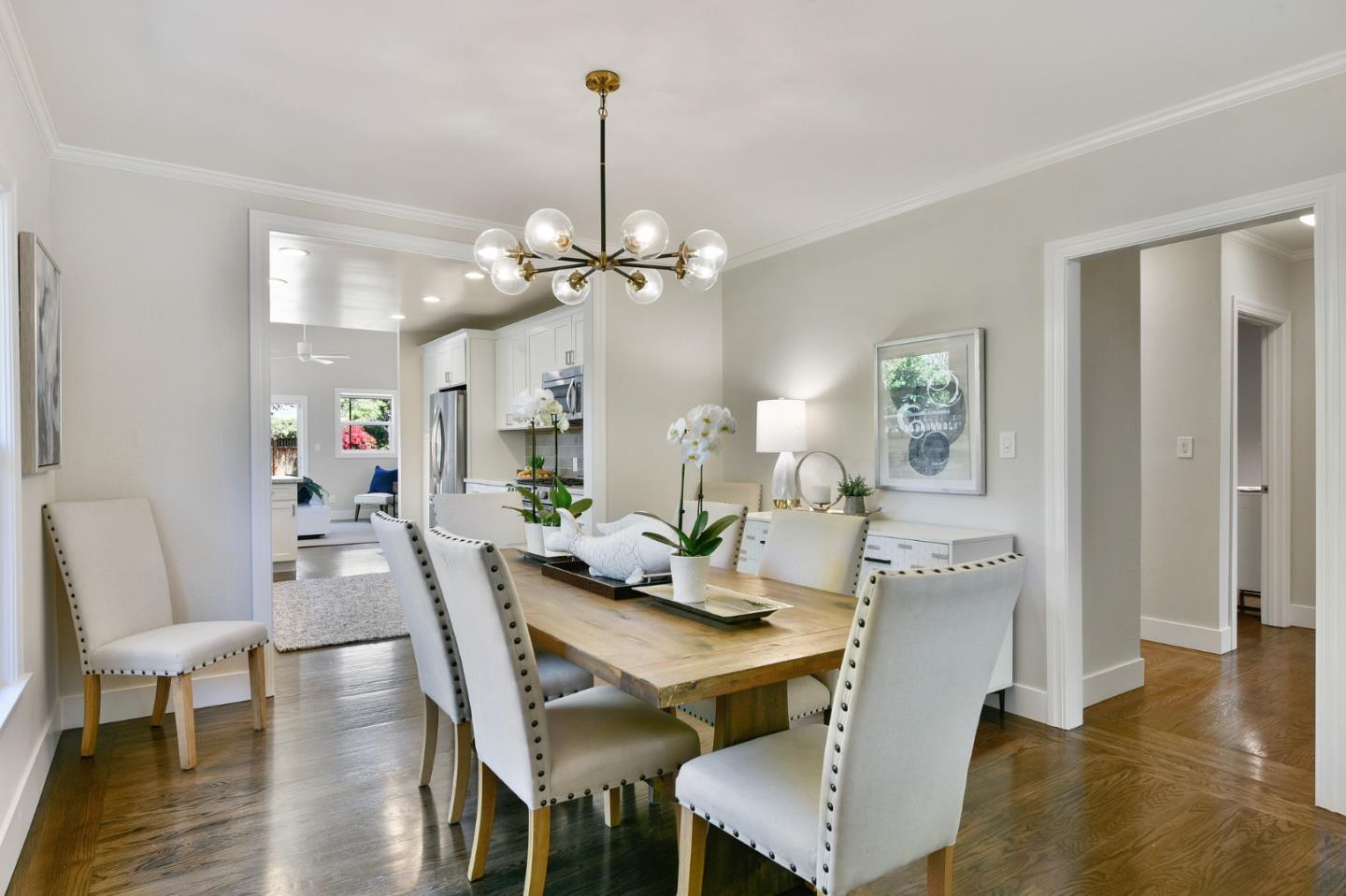 232 Bancroft Road Burlingame, CA 94010 - Photo 21 of 69 a view of a dining room with furniture wooden floor and chandelier