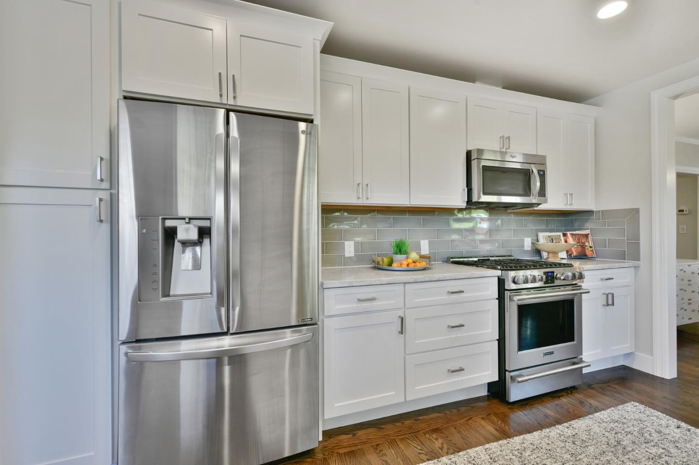232 Bancroft Road Burlingame, CA 94010 - Photo 29 of 69 a kitchen with stainless steel appliances white cabinets and a refrigerator