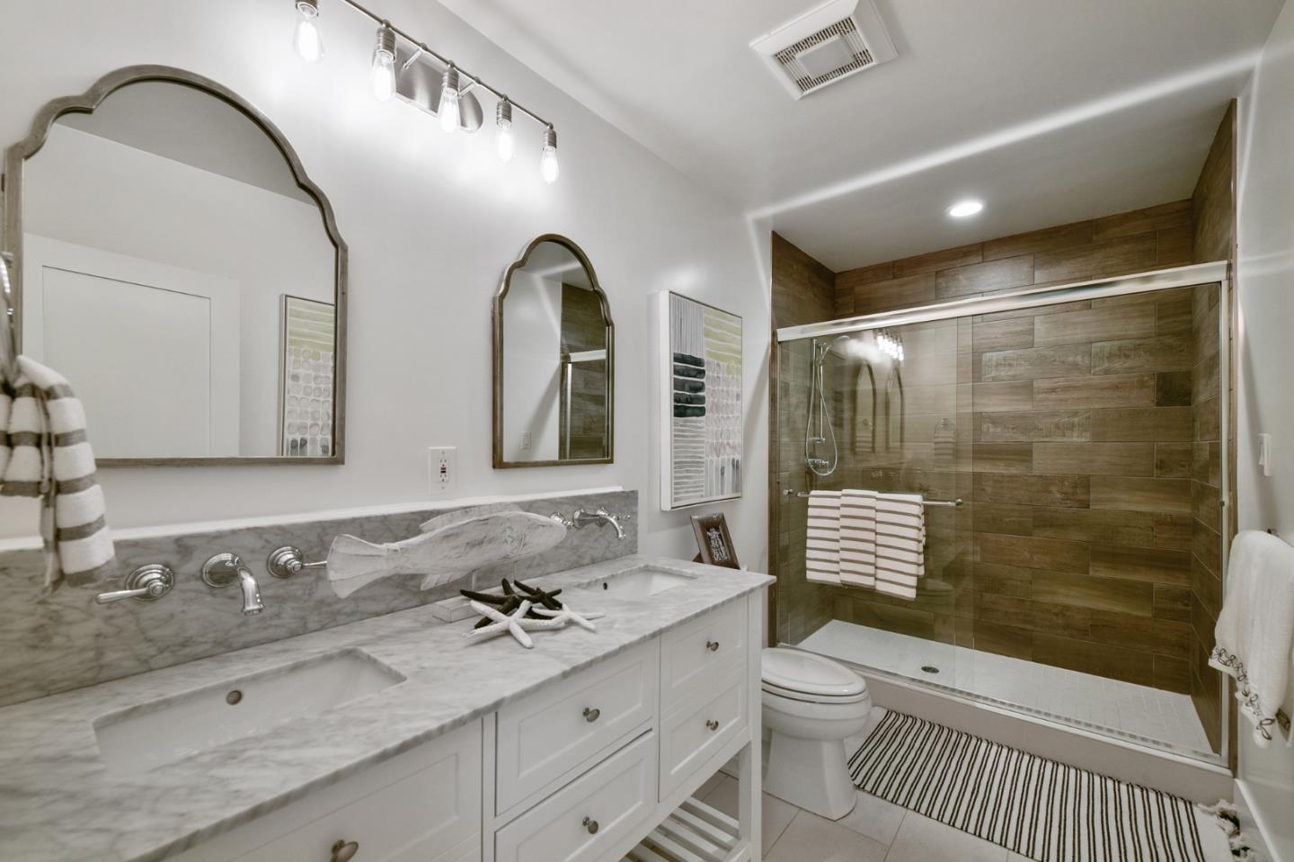 232 Bancroft Road Burlingame, CA 94010 - Photo 48 of 69 a bathroom with a double vanity sink toilet and shower