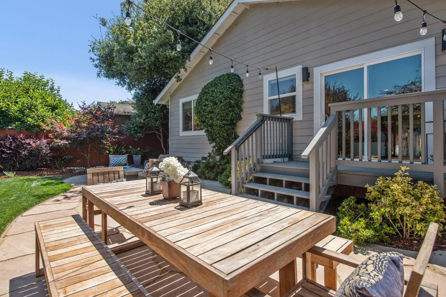 232 Bancroft Road Burlingame, CA 94010 - Photo 54 of 69 a view of a patio with table and chairs potted plants with wooden floor and fence