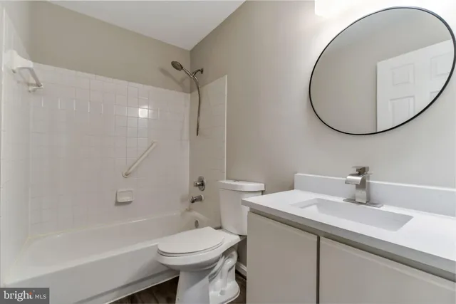 a bathroom with a sink a toilet and a mirror