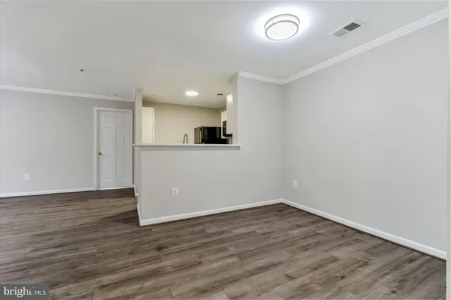 a view of a kitchen with a microwave and wooden floor