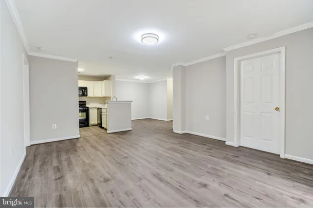 a view of a kitchen with a sink and a refrigerator