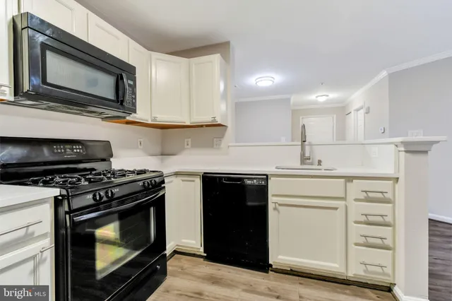 a kitchen with stainless steel appliances granite countertop a stove top oven microwave and cabinets