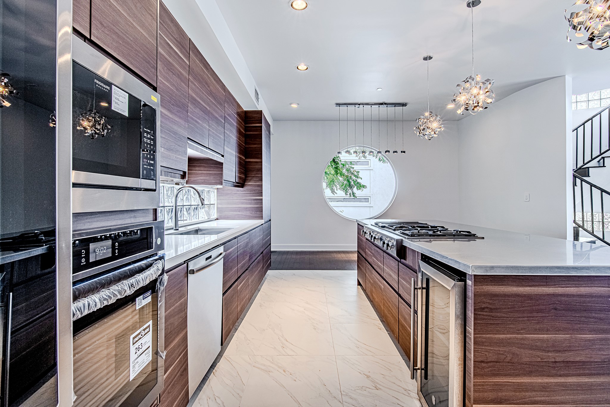 2025 Colquitt Street, Unit E Houston, TX 77098 - Photo 10 of 29 Kitchen with built-in appliances and ample cabinetry for storage.
