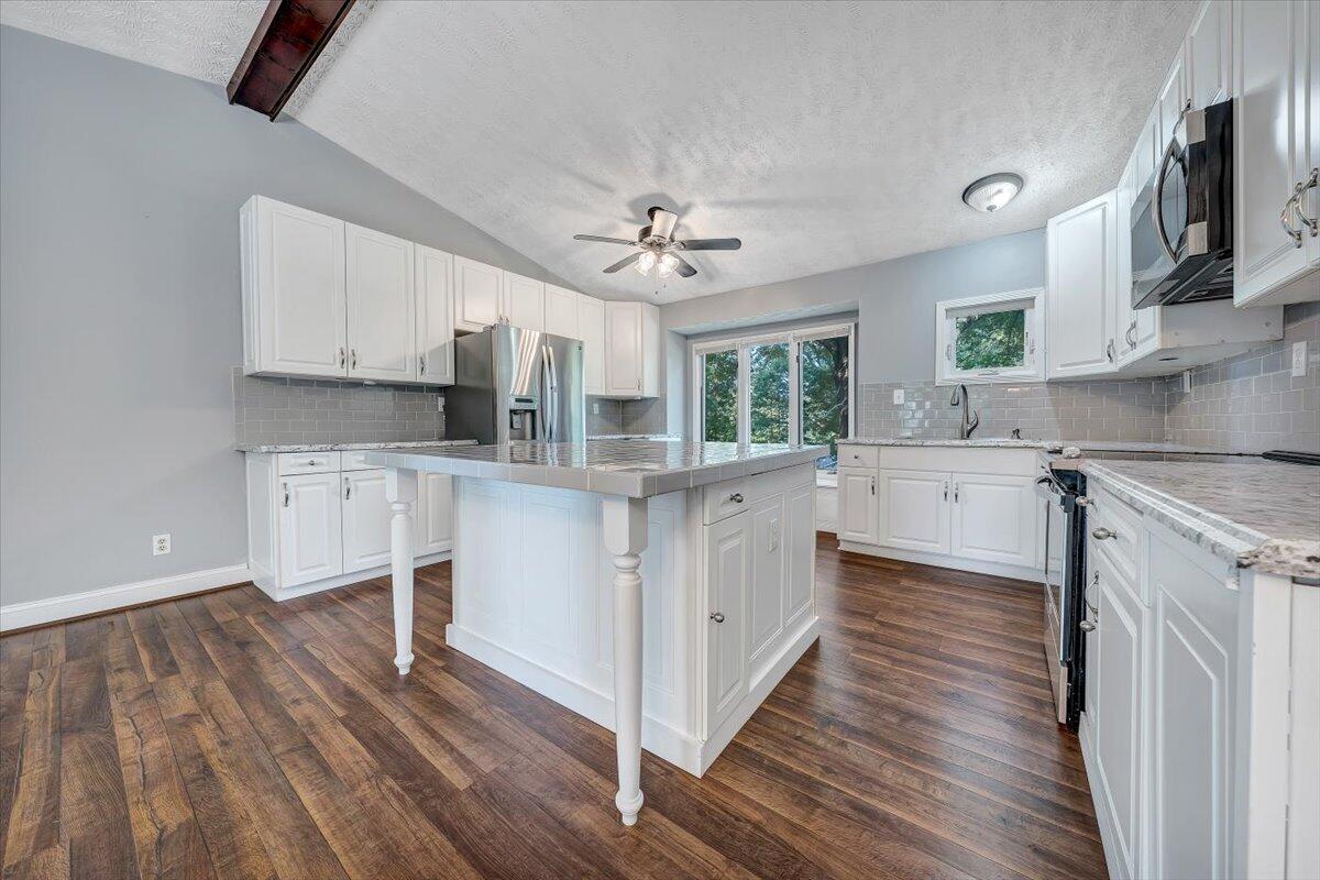 80 Walnut Landing Circle Hardy, VA 24101 - Photo 12 of 34 a kitchen with granite countertop a stove a sink and a refrigerator with wooden floor