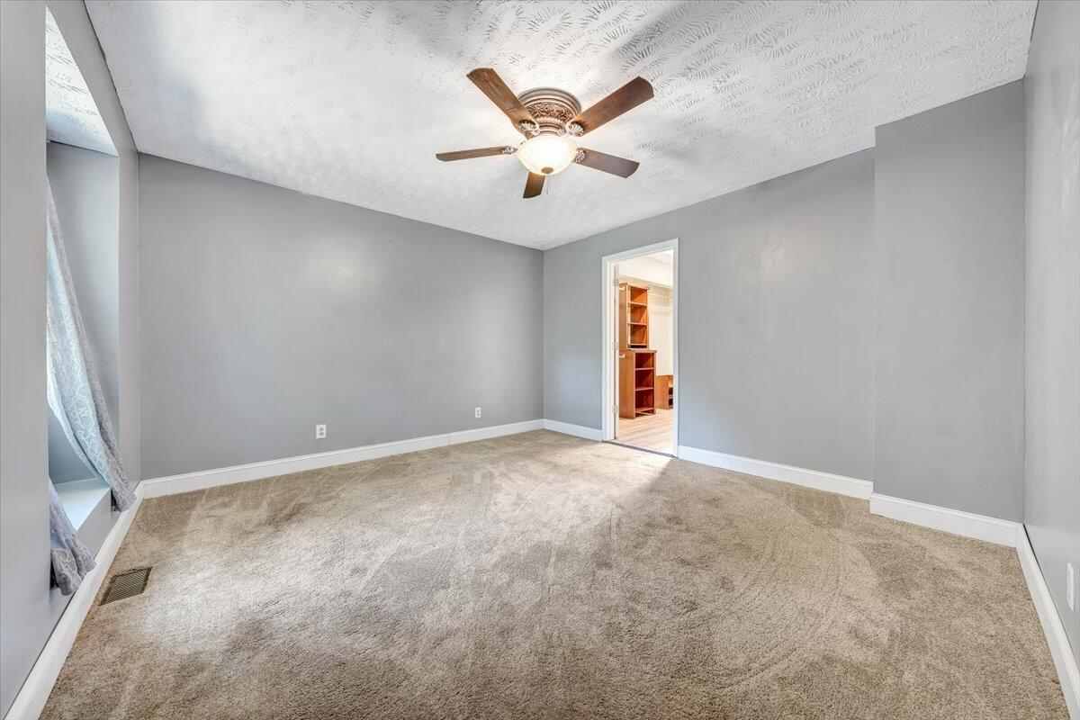 80 Walnut Landing Circle Hardy, VA 24101 - Photo 20 of 34 an empty room with ceiling fan and window