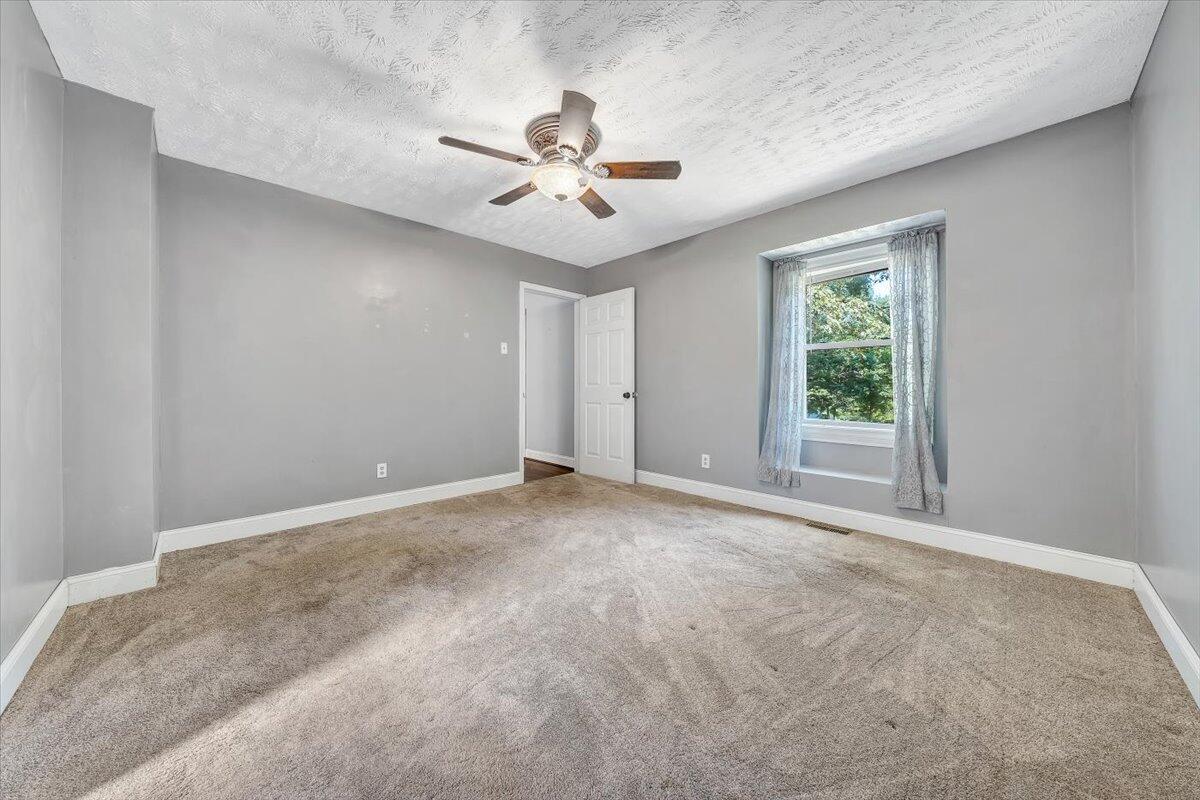 80 Walnut Landing Circle Hardy, VA 24101 - Photo 21 of 34 a view of a livingroom with a ceiling fan and window