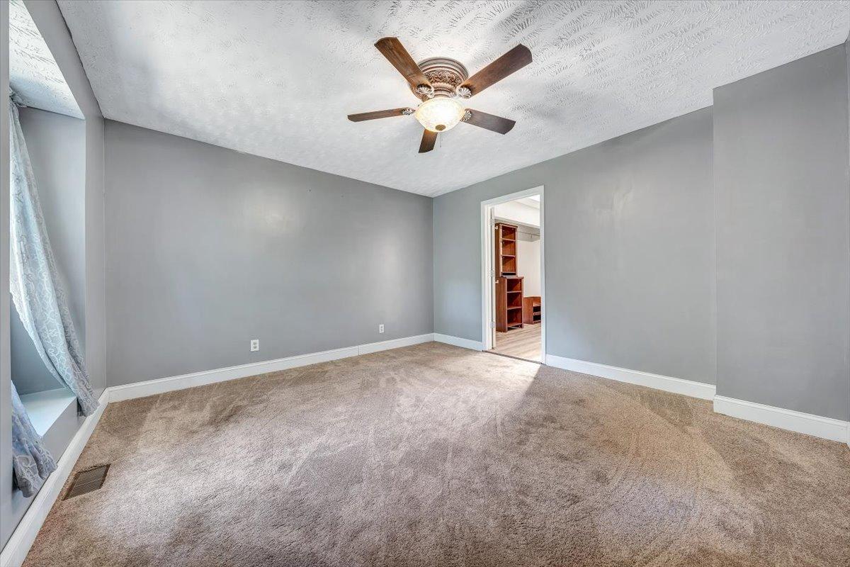 80 Walnut Landing Circle Hardy, VA 24101 - Photo 22 of 34 an empty room with ceiling fan and window