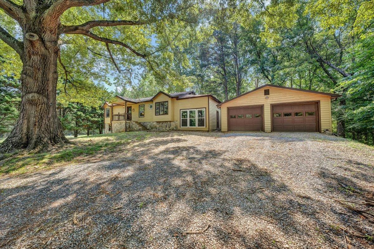 80 Walnut Landing Circle Hardy, VA 24101 - Photo 5 of 34 a front view of a house with a garden and trees