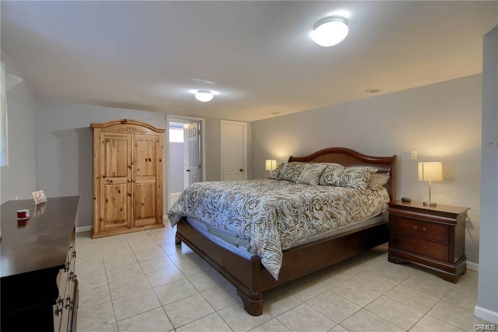 7428 Hornitos Road Hornitos, CA 95325 - Photo 18 of 46 a spacious bedroom with a bed and a cabinets