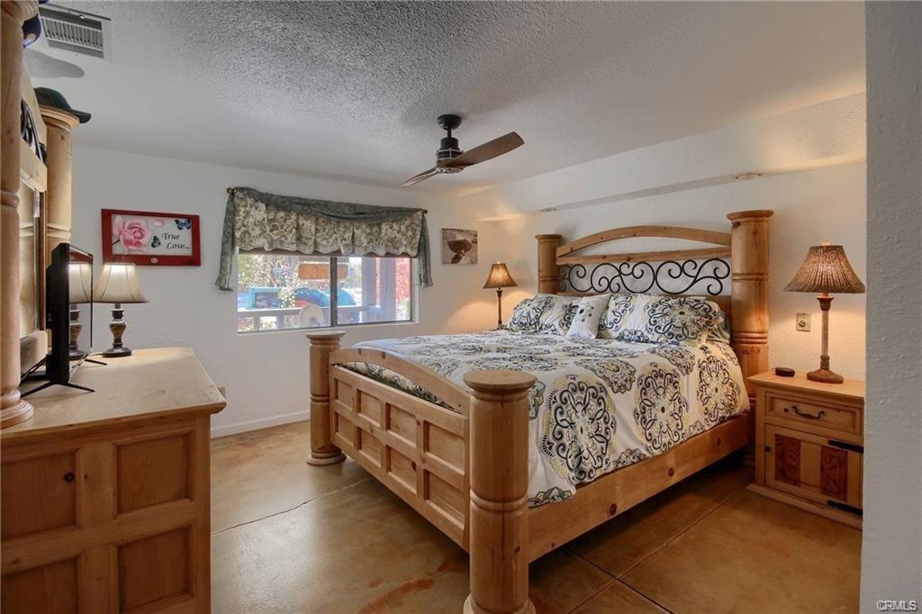 7428 Hornitos Road Hornitos, CA 95325 - Photo 22 of 46 a bedroom with a bed and a flat tv screen on the dresser
