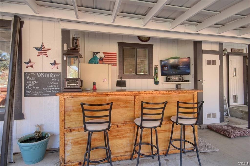 7428 Hornitos Road Hornitos, CA 95325 - Photo 30 of 46 a kitchen with stainless steel appliances kitchen island granite countertop a table and chairs in it