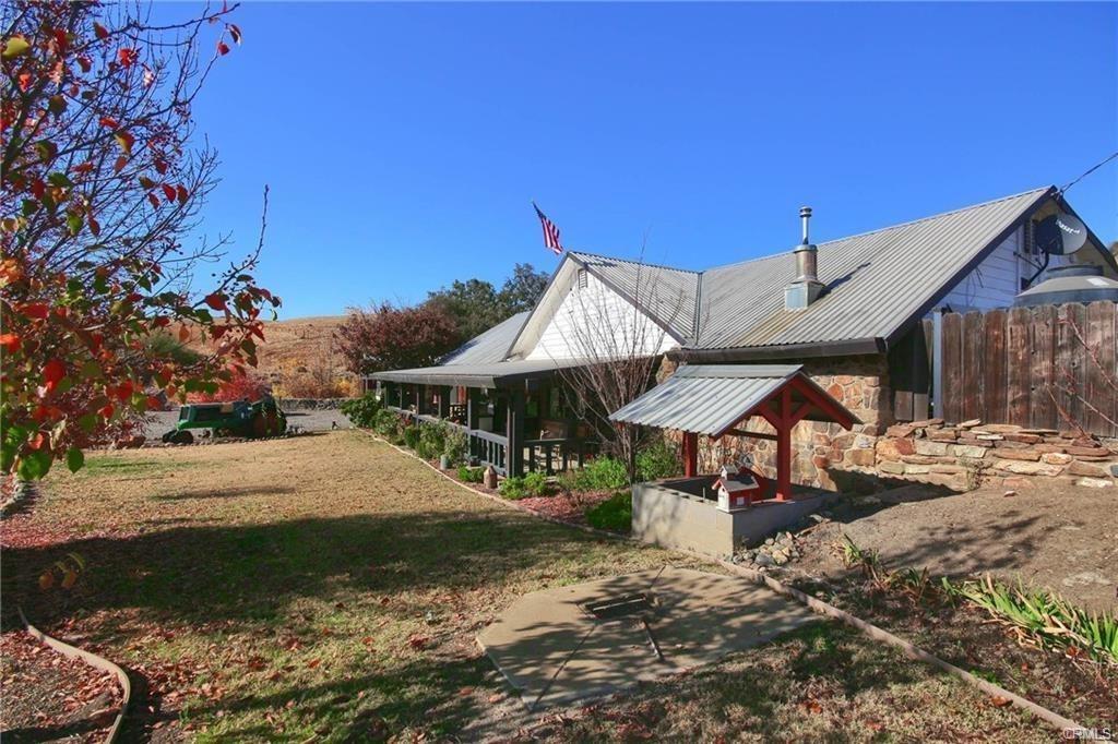 7428 Hornitos Road Hornitos, CA 95325 - Photo 41 of 46 a patio with a table and chairs under an umbrella