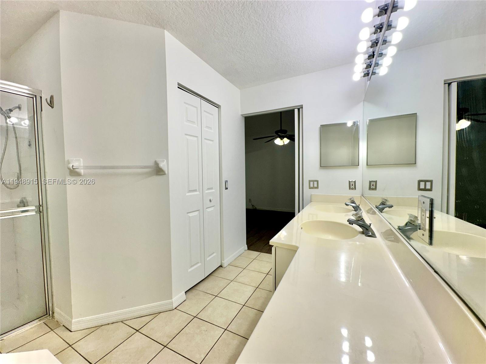 1013 Via Jardin Riviera Beach, FL 33418 - Photo 12 of 18 a spacious bathroom with a double vanity sink and a mirror