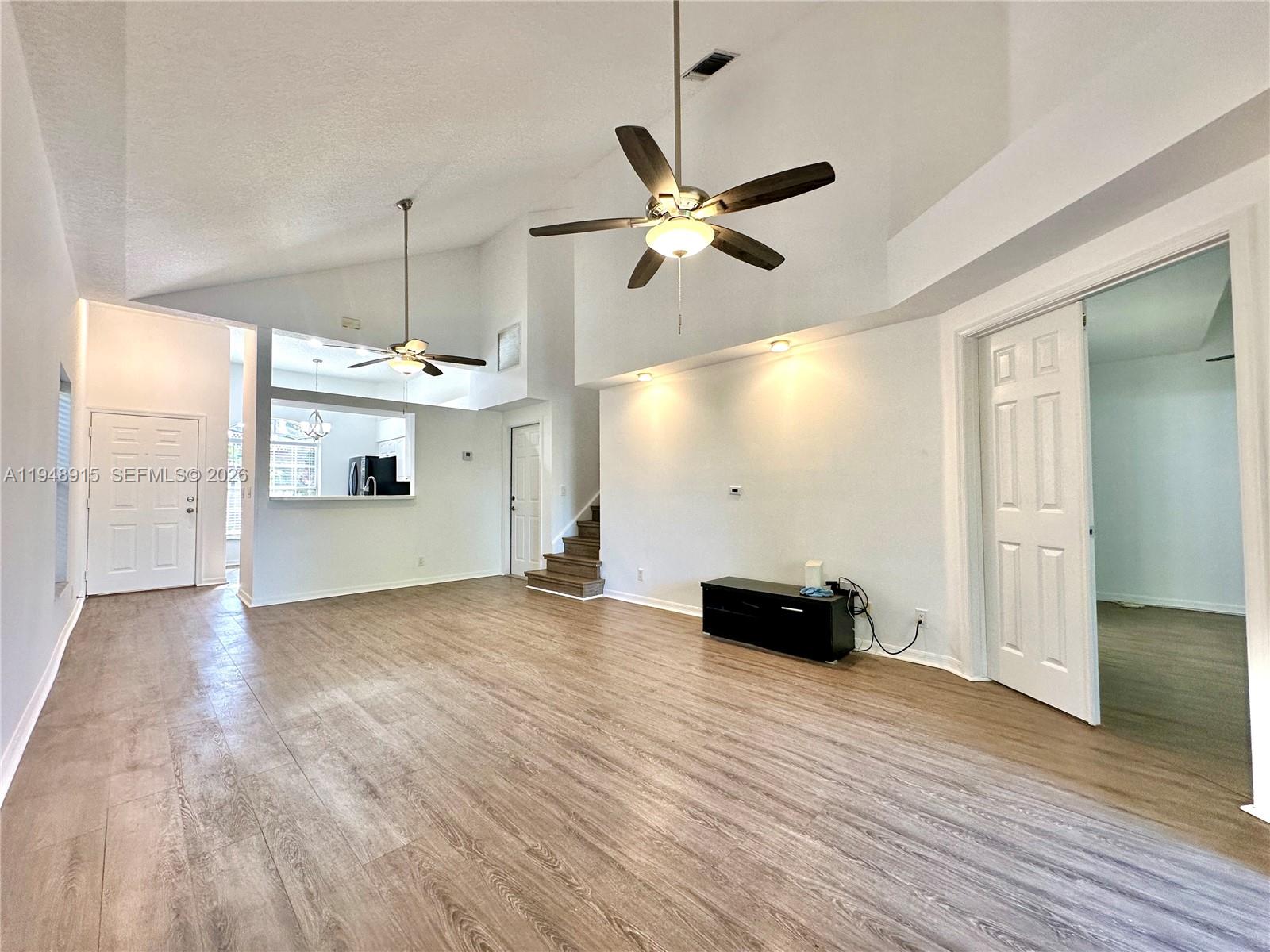 1013 Via Jardin Riviera Beach, FL 33418 - Photo 5 of 18 a view of an empty room with wooden floor and a window