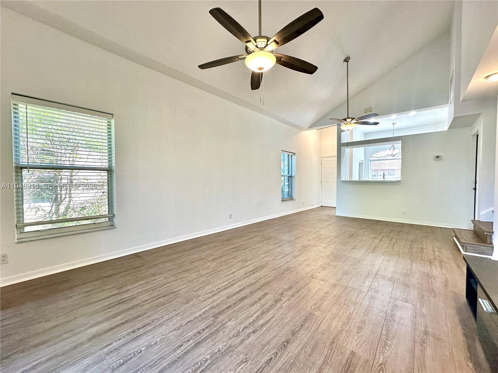 1013 Via Jardin Riviera Beach, FL 33418 - Photo 6 of 18 a view of an empty room with a window and wooden floor