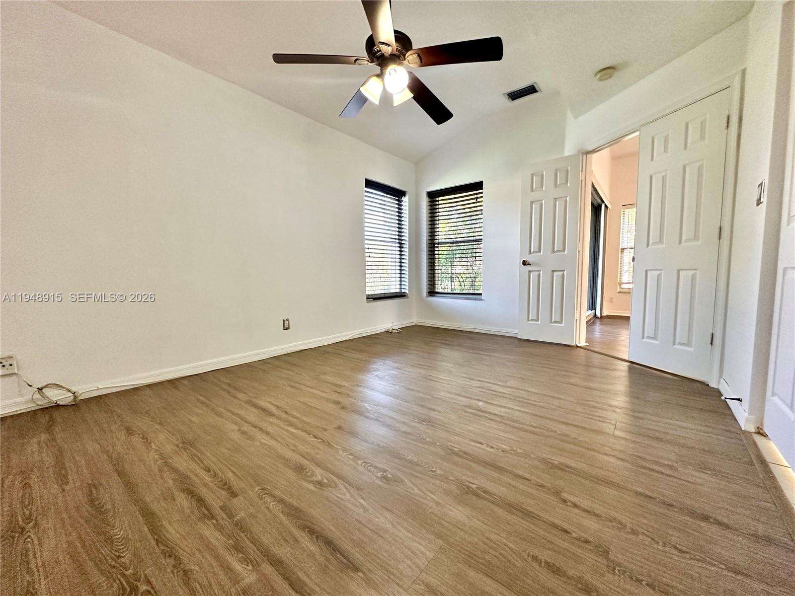 1013 Via Jardin Riviera Beach, FL 33418 - Photo 9 of 18 wooden floor in an empty room with a window