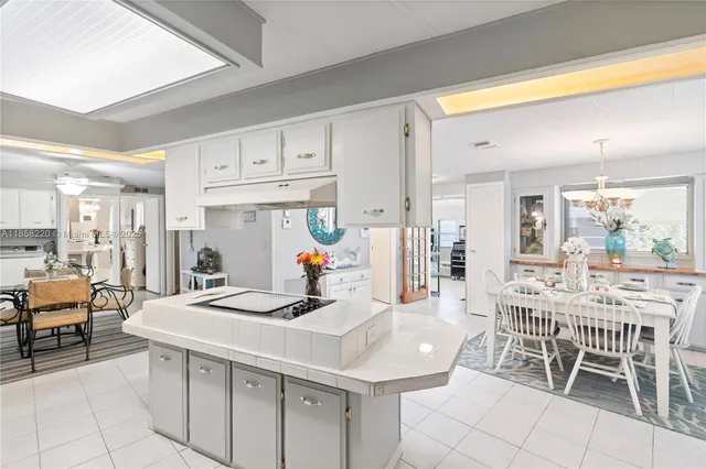 a kitchen with stainless steel appliances kitchen island granite countertop a sink and cabinets