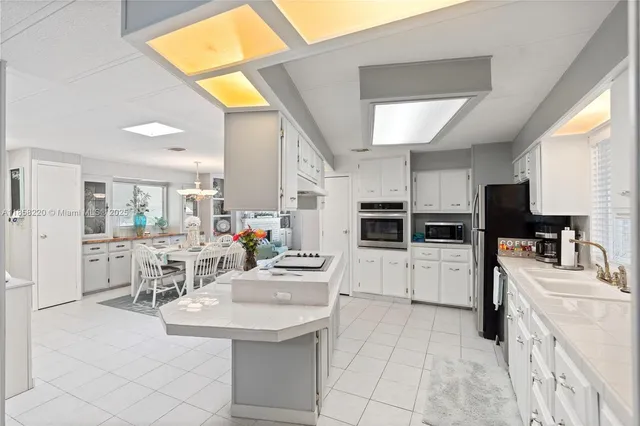 a kitchen with refrigerator and cabinets