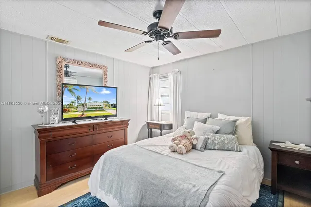 a spacious bedroom with a large bed and a chandelier