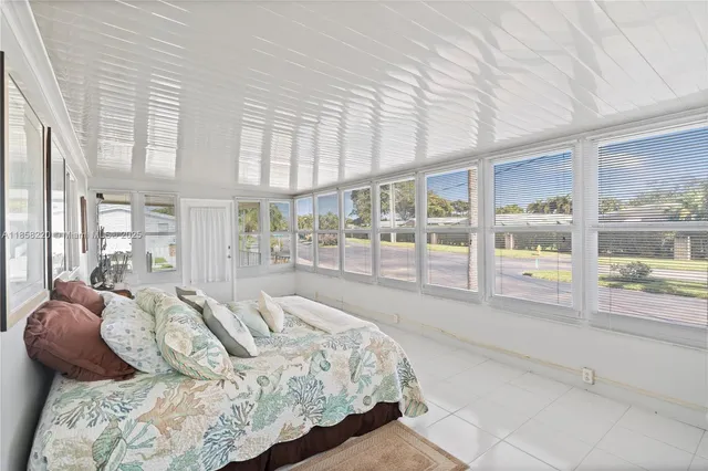 a bedroom with a large bed and a large window