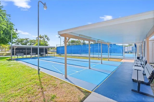 a swimming pool with outdoor seating and garden