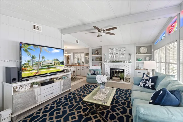 a view of a dining room and livingroom with furniture wooden floor and a rug