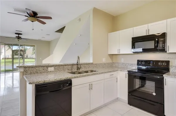 a kitchen with a stove microwave and a sink