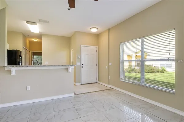 a view of a big room with windows and entryway