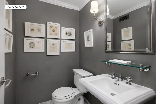 a bathroom with a sink mirror and toilet