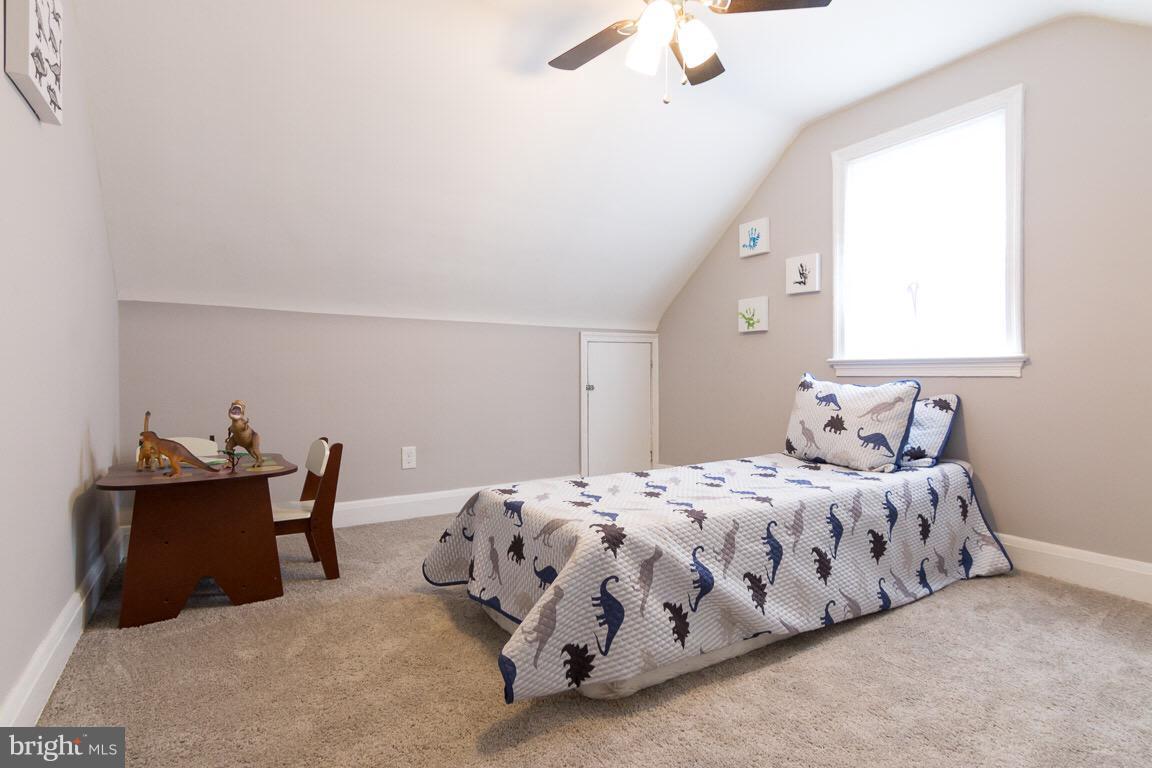 3613 Forest Hill Road Baltimore, MD 21207 - Photo 13 of 27 a bedroom with a bed and a dresser